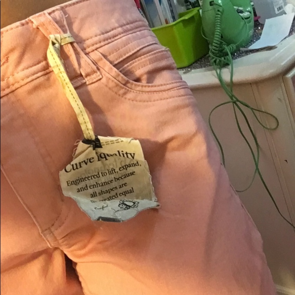 Light coral-ish pink pants.